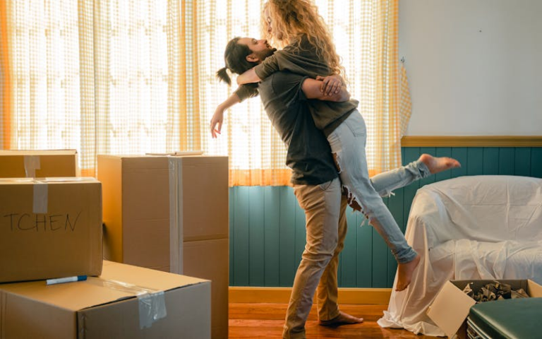 Husband hugging wife in their new home.