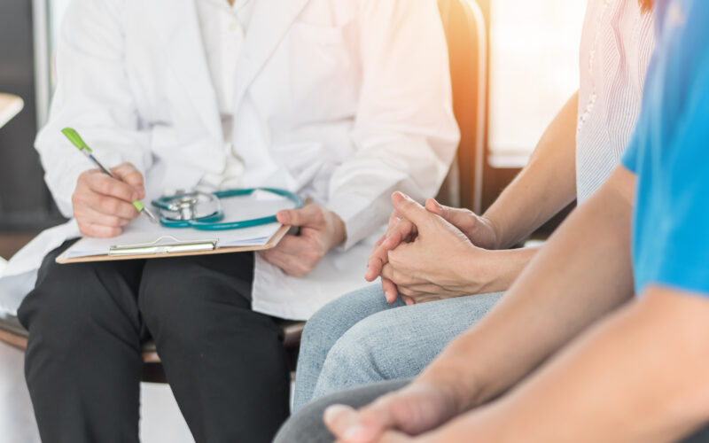 Couple meeting with doctor.