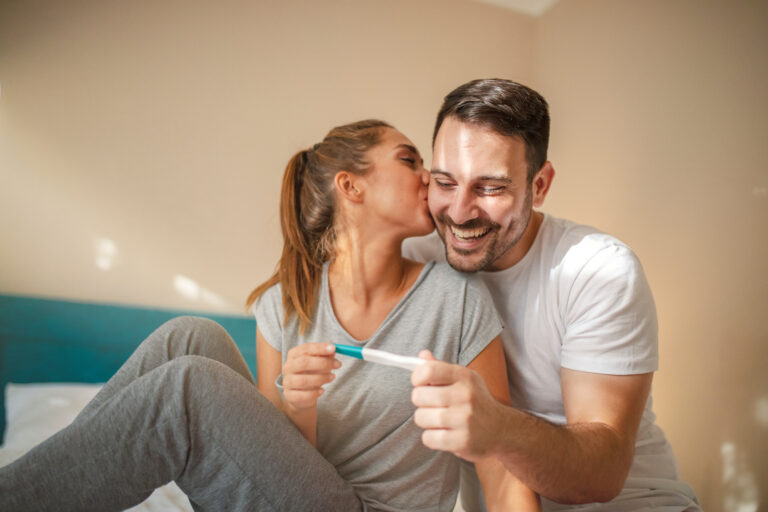 Happy couple with pregnancy test